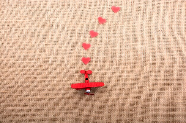 Heart shaped objects behind an airplane