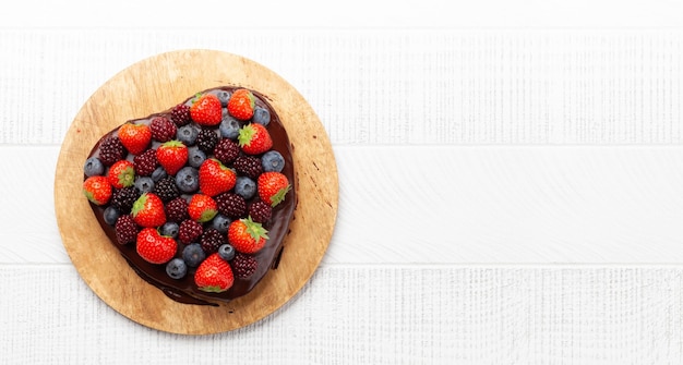 Heart shaped sweet cake with berries