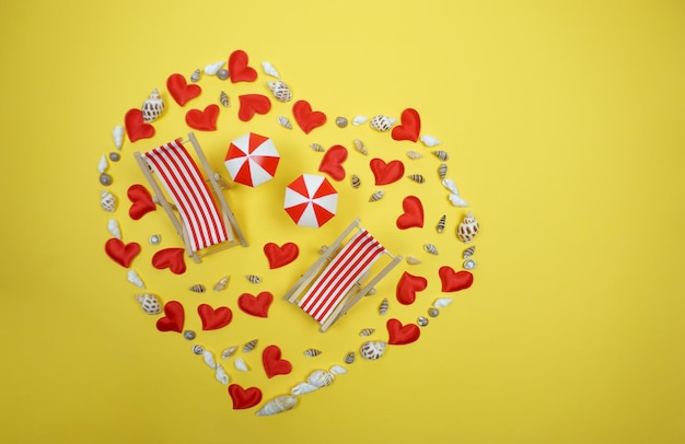 A heart of shells and hearts is laid out on a yellow background