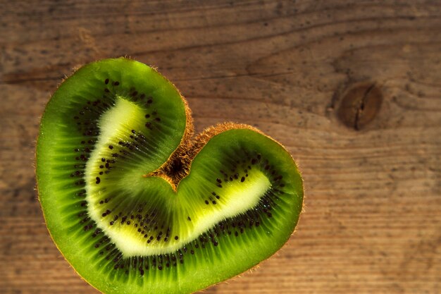 heart sliced kiwi on wooden textured table