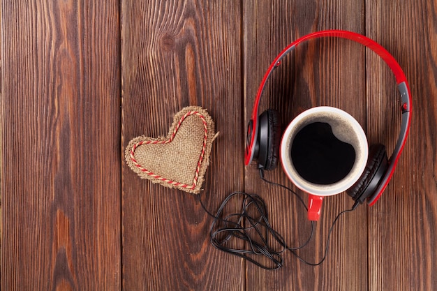 Heart toy with headphones and coffee cup