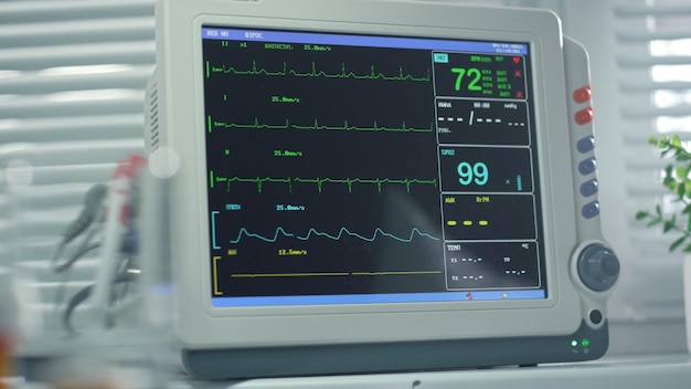 Photo heartbeat monitor screen showing pulse vital signs in operating room closeup