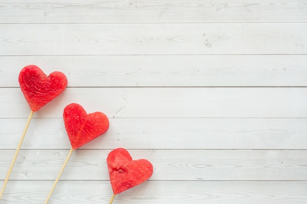 Hearts carved from watermelon on a stick. Concept of Valentine's