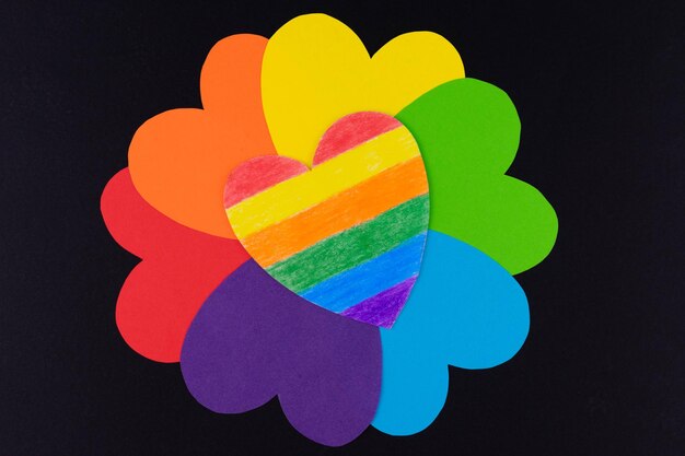 Hearts in the colors of the LGBT community flag in the form of a flower on a black background