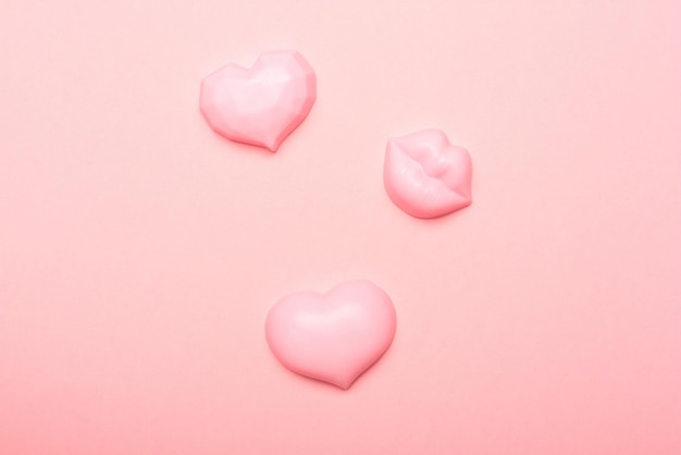 Hearts and lips from soap on a pink background