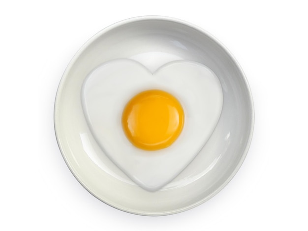 Heartshaped omelet fried egg on ceramic plates isolated on white background