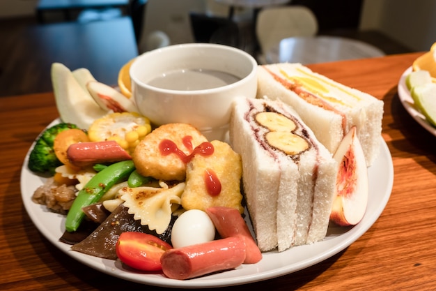 Hearty breakfast with bread and fruit on a plate at home