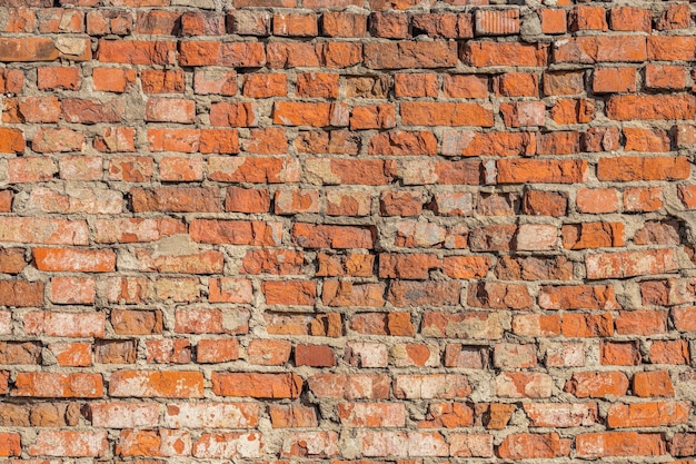 Heavily weathered brick wall texture and background with deep water erosion