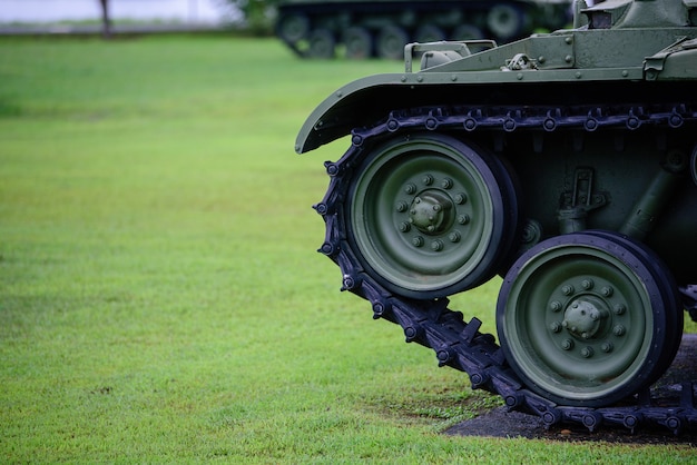 Heavy military tank parked on the grass