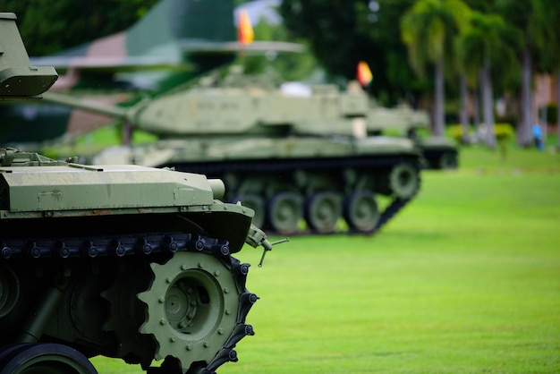 Heavy military tank parked on the grass