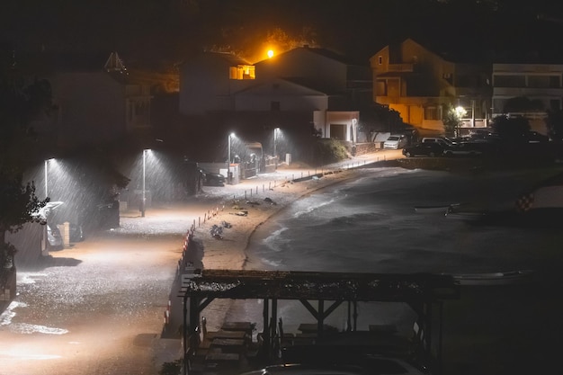 Heavy rain at night on the beach in the resort town Storm by the sea at night