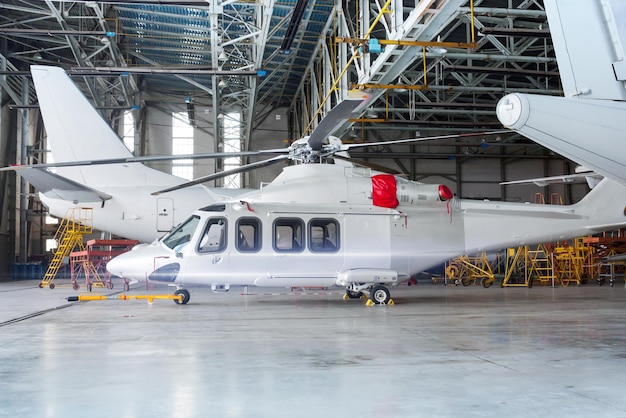 Helicopter and airplanes under maintenance Checking mechanical systems for flight operations