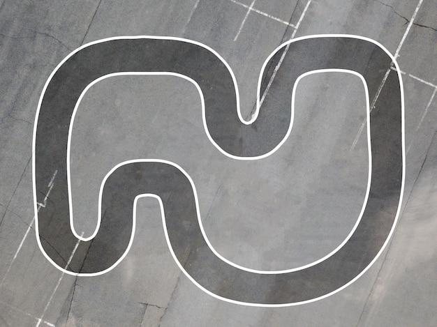 Helicopter helipad on the asphalt surface with letter H view from above