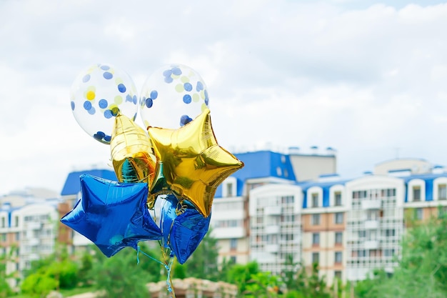 Helium balloons on background of city