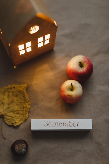 Hello september autumn card with fresh red apples on white background top view