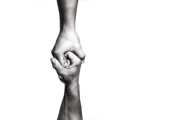 Helping hand concept and international day of peace, support. Helping hand outstretched, isolated arm, salvation. Close up help hand. Two hands, helping arm of a friend, teamwork. Black and white.