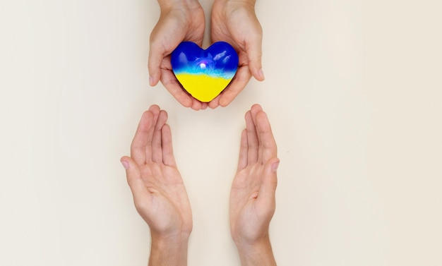 A helping hand helps Ukraine a heart in Ukrainian colors