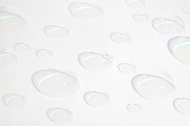 A hemisphere of a transparent soap bubbles on white background with trendy shadows