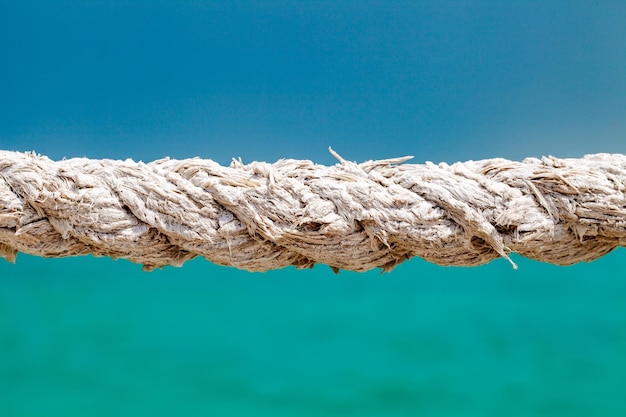 Hemp rope old closeup on the background of the sea selective focus