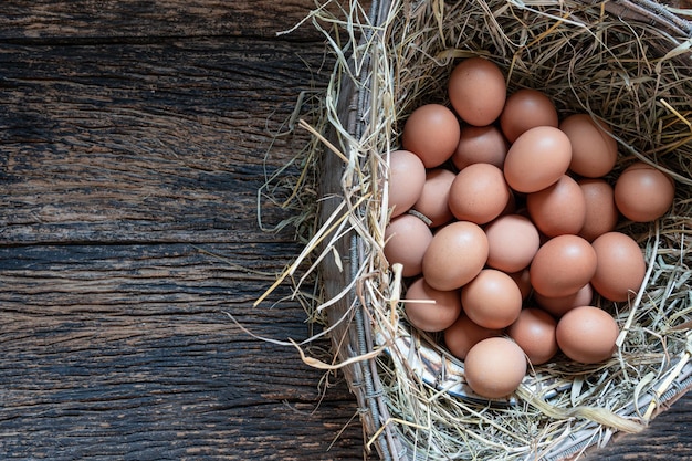 Hen / chicken eggs basket on the hey.Fresh Chicken Rooster Eggs on Hay at Local Farmer Market