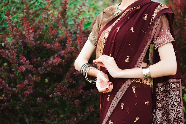 Henna wedding design, Woman Hands with black mehndi tattoo. Hands of Indian bride woman with black henna tattoos. Fashion. India