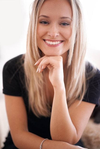 Her smile puts everyone at ease Portrait of a young woman sitting with her hand on her chin