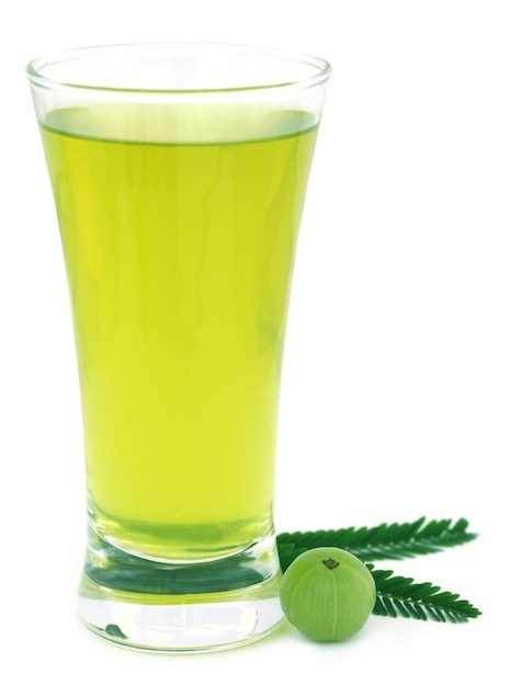 Herbal amla juice with fresh fruit over white background