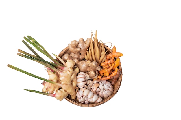 Herbal food seasoning which includes gingergalingale turmeric and garlic placed on a rattan tray