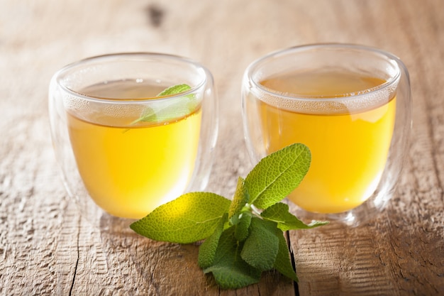 Herbal sage tea with green leaves in glass cups