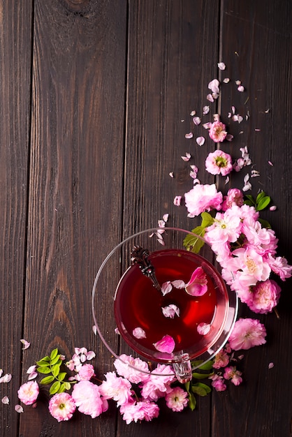 Herbal tea ingredients with flowers and cup of tea