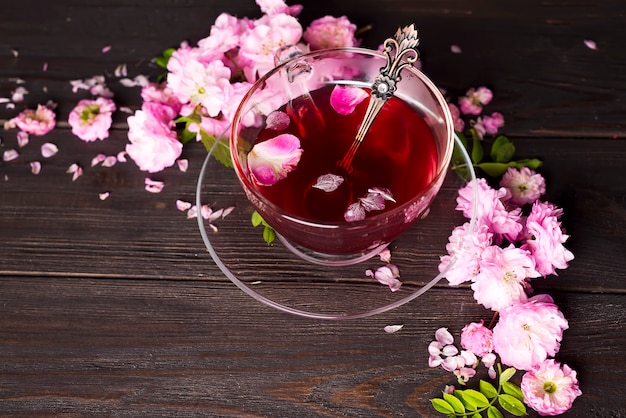 Herbal tea ingredients with flowers and cup of tea