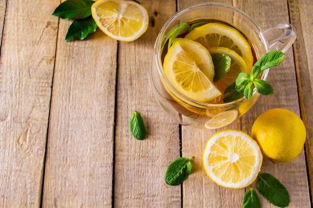 Herbal tea with lemon and mint on wooden background Delicious drink for relaxation and alternative therapy of diseases