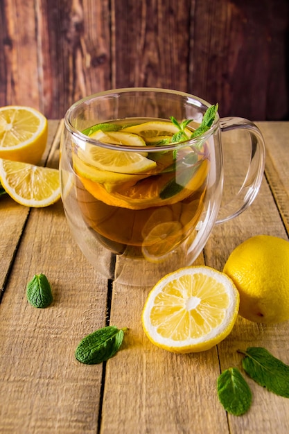 Herbal tea with lemon and mint on a wooden