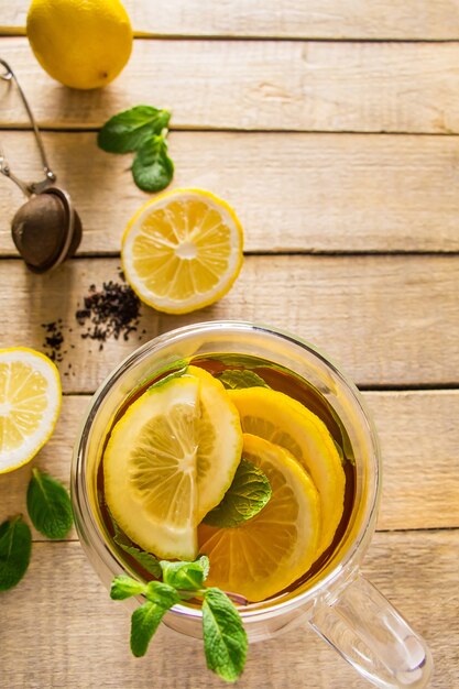 Herbal tea with lemon and mint on a wooden