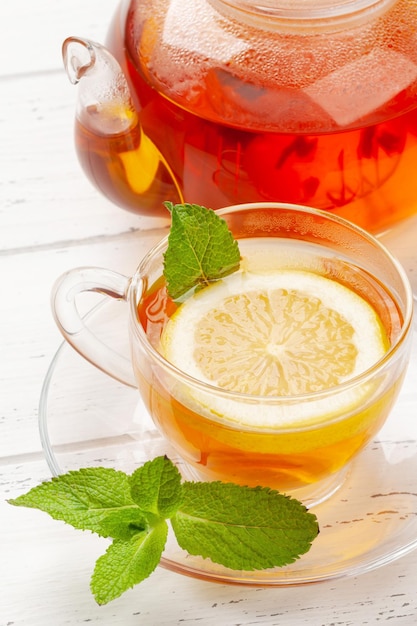 Herbal tea with mint and lemon Tea cup and teapot