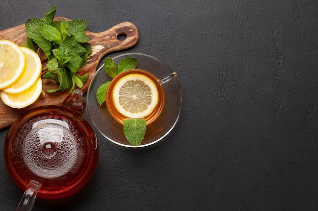 Herbal tea with mint and lemon Tea cup and teapot