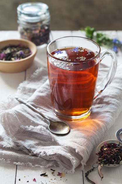 Herbal tea with a spoon on linen