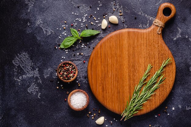 Herbs and condiments on black stone background Top view with copy space