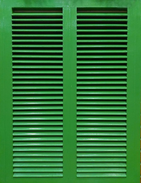 Heritage or Colonial louver window shutter or jalousie window in dark green oil spray paint finish