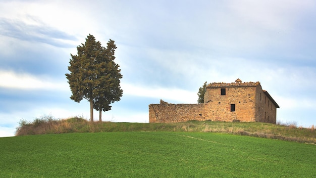 Hermitage crumbling in the meadow in Tuscany Italy