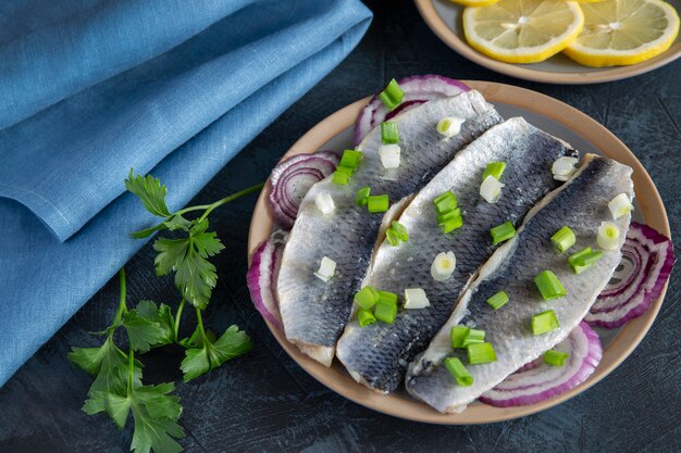 Herring fillet with onions, parsley, lemon