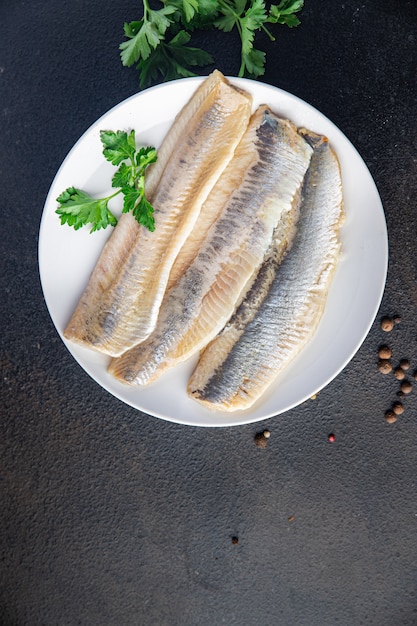 herring fish fillet seafood a portion ready to eat meal snack on the table copy space food