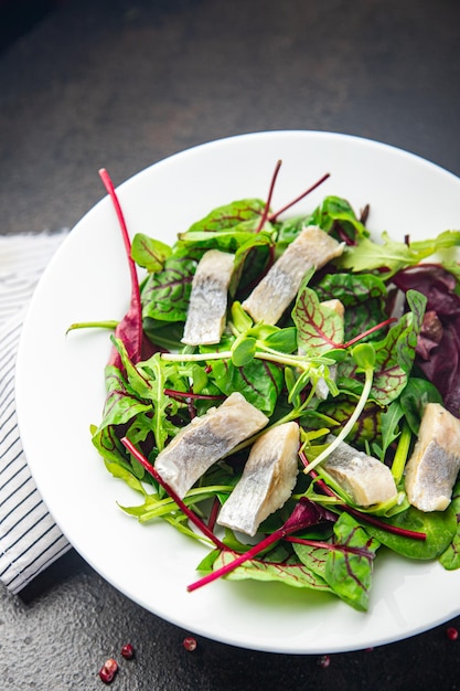 Herring salad fish slices seafood green mix leaf lettuce ready to eat fresh portion healthy meal