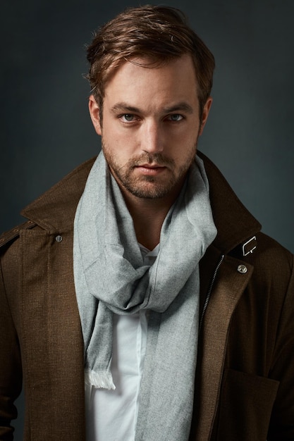 Hes got a great sense of style Studio portrait of a handsome young man posing against a dark background