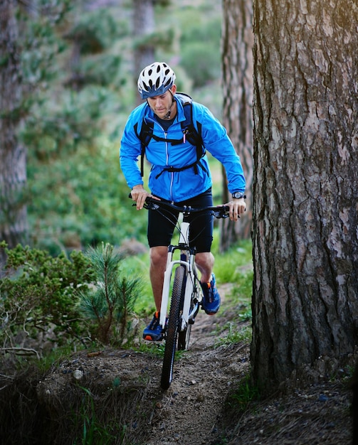 Hes one determined mountain biker Shot of a male cyclist riding along a mountain bike trail