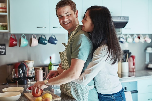 Photo hes the perfect husband cropped shot of an affectionate couple standing in the kitchen