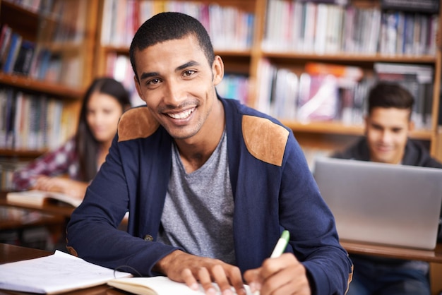 Hes such a diligent student Cropped portrait of a handsome young student working diligently in his classroom