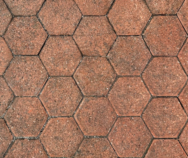 Photo hexagon outdoor paving stone tiles paving cobble stone in red terracotta stone color