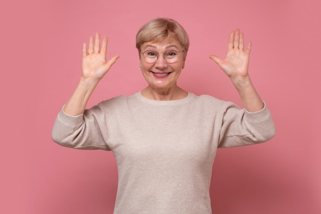 Hi Hello concept Mature woman waving hand welcome her friends