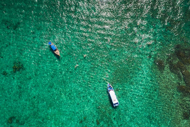 Hi season boat and tourists on phiphi island Krabi Thailand aerial view from drone 